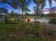 Mid-century modern home with a two-car garage and landscaped lawn at 3644 Lake Shore Dr, Apopka, FL 32703