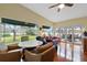 Spacious Gathering room offers hardwood floors, ample natural light and scenic water views at 3644 Lake Shore Dr, Apopka, FL 32703