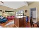 Bright kitchen features wood cabinets, granite counters, and stainless steel appliances at 3644 Lake Shore Dr, Apopka, FL 32703