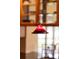 Close-up of a stylish red and black glass pendant light at 3644 Lake Shore Dr, Apopka, FL 32703