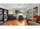 Bright sunroom with water views and hardwood floors at 3644 Lake Shore Dr, Apopka, FL 32703
