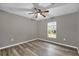 Spacious bedroom with ceiling fan and large window at 395 Alcazar Ave, De Leon Springs, FL 32130