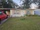 Ranch-style home with a large front yard and mature trees at 4419 Lake Lawne Ave, Orlando, FL 32808