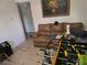 Living room with a brown couch and foosball table at 4419 Lake Lawne Ave, Orlando, FL 32808