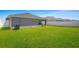 Backyard view of home with grassy lawn at 4505 Hummingbird Ln, Haines City, FL 33844