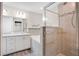 Modern bathroom featuring a double vanity, soaking tub and glass-enclosed shower with tiled walls at 4505 Hummingbird Ln, Haines City, FL 33844