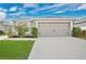 Charming home featuring a two-car garage and well-maintained front lawn under a bright, cloudy sky at 4505 Hummingbird Ln, Haines City, FL 33844
