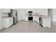 Bright, modern kitchen featuring stainless steel appliances, white cabinets, and stylish wood-look flooring at 4505 Hummingbird Ln, Haines City, FL 33844