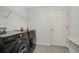 Well-lit laundry room with shelving, modern washer and dryer, and practical vinyl flooring at 4505 Hummingbird Ln, Haines City, FL 33844