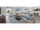 Bright living room featuring neutral furniture, blue accents, and sliding glass doors to the outdoor area at 4505 Hummingbird Ln, Haines City, FL 33844