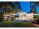 House with lighted lawn and pool at night at 541 Virginia Dr, Winter Park, FL 32789