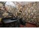 Elegant powder room with patterned wallpaper and black fixtures at 541 Virginia Dr, Winter Park, FL 32789
