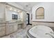Spa-like bathroom with a soaking tub, double vanity, and marble finishes at 541 Virginia Dr, Winter Park, FL 32789