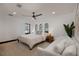 Bright bedroom with a king-size bed, daybed, and large windows at 541 Virginia Dr, Winter Park, FL 32789