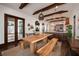 Bright dining area with a long wooden table, kitchen views, and hardwood floors at 541 Virginia Dr, Winter Park, FL 32789