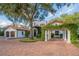 Spanish style home with lush landscaping and brick driveway at 541 Virginia Dr, Winter Park, FL 32789