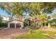 Spanish style home with brick driveway, lush landscaping, and two-car garage at 541 Virginia Dr, Winter Park, FL 32789