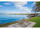 Relaxing lakefront view with wooden chairs at 541 Virginia Dr, Winter Park, FL 32789