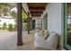 Relaxing patio with seating area, wood columns, and access to the backyard at 541 Virginia Dr, Winter Park, FL 32789