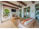 Covered patio with seating, fireplace, and access to pool area at 541 Virginia Dr, Winter Park, FL 32789