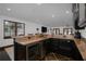 Custom wet bar with granite countertop and wine cooler at 541 Virginia Dr, Winter Park, FL 32789