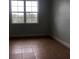 Spacious bedroom with large window and tile flooring at 6413 Astor Village Ave # 314, Orlando, FL 32835