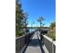 Scenic walkway to a gazebo overlooking a peaceful lake at 6413 Astor Village Ave # 314, Orlando, FL 32835
