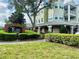 Attractive building entrance with prominent signage amidst well-maintained landscaping at 6413 Astor Village Ave # 314, Orlando, FL 32835