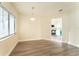 Light-filled dining area with hardwood floors and view of kitchen at 667 Oregon Woods Ct, Orlando, FL 32824