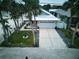 Single story home with driveway and tropical landscaping at 821 E 1St Ave, New Smyrna Beach, FL 32169