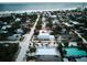Aerial view of a two-story house near the beach in a neighborhood with various house styles at 821 E 1St Ave, New Smyrna Beach, FL 32169