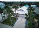 An aerial view of a house with a white metal roof and a driveway at 821 E 1St Ave, New Smyrna Beach, FL 32169