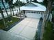 Single story home with driveway and tropical landscaping at 821 E 1St Ave, New Smyrna Beach, FL 32169