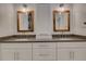 Bathroom with double vanity and wood framed mirrors at 821 E 1St Ave, New Smyrna Beach, FL 32169
