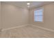 Bright bedroom with light grey walls and wood-look flooring at 821 E 1St Ave, New Smyrna Beach, FL 32169
