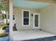 Covered front porch with light-colored flooring and a light blue ceiling at 821 E 1St Ave, New Smyrna Beach, FL 32169