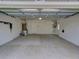 Attached garage with concrete floor and overhead storage at 821 E 1St Ave, New Smyrna Beach, FL 32169