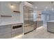 Modern kitchen with stainless steel appliances and gray cabinets, white countertops at 821 E 1St Ave, New Smyrna Beach, FL 32169