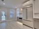Modern kitchen with stainless steel appliances and white and gray cabinets at 821 E 1St Ave, New Smyrna Beach, FL 32169
