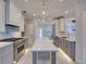 Modern kitchen with stainless steel appliances, gray cabinets, and a white countertop at 821 E 1St Ave, New Smyrna Beach, FL 32169