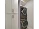Stackable washer and dryer with white cabinets at 821 E 1St Ave, New Smyrna Beach, FL 32169