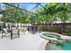 Screened pool and spa with outdoor dining area at 8845 Warwick Shore Xing, Orlando, FL 32829