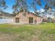 Spacious backyard with a patio and lush lawn at 9606 Chandon Dr, Orlando, FL 32825