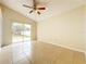 Bright bedroom with tile floors and sliding glass doors leading to the backyard at 9606 Chandon Dr, Orlando, FL 32825