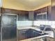 Updated kitchen, featuring granite counters and dark wood cabinets at 9606 Chandon Dr, Orlando, FL 32825