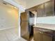 Black appliances and dark wood cabinets in this galley kitchen at 9606 Chandon Dr, Orlando, FL 32825