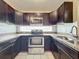 Modern kitchen with granite countertops and stainless steel appliances at 9606 Chandon Dr, Orlando, FL 32825