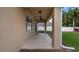 Covered patio with ceiling fan, adjacent to grassy backyard at 10097 Leland Dr, Orlando, FL 32827