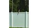 A hawk perched on a white fence in a natural setting at 10097 Leland Dr, Orlando, FL 32827