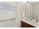 Modern bathroom featuring a white vanity, white countertops, contemporary mirror and neutral paint at 10097 Leland Dr, Orlando, FL 32827